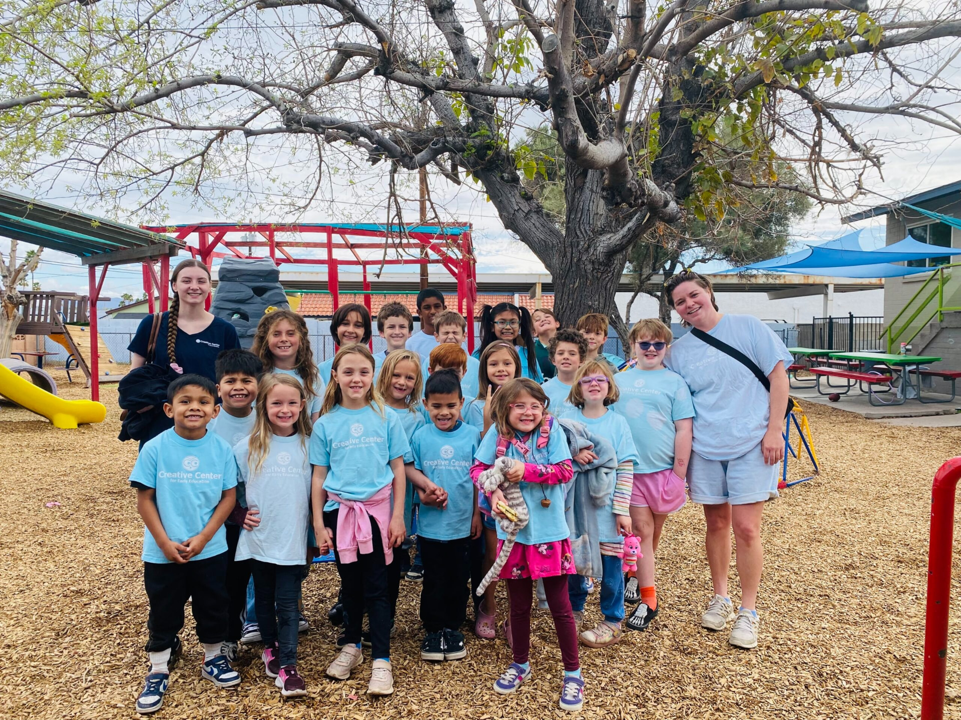 Creative Center school-age children and their teachers on the playground